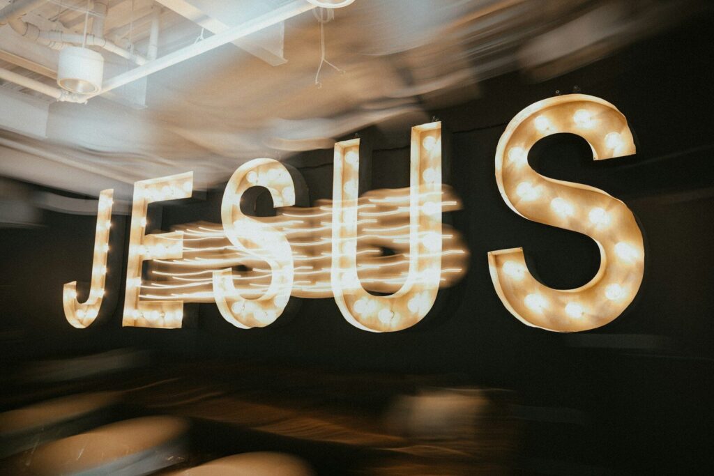 The word "jesus" illuminated in bright lights